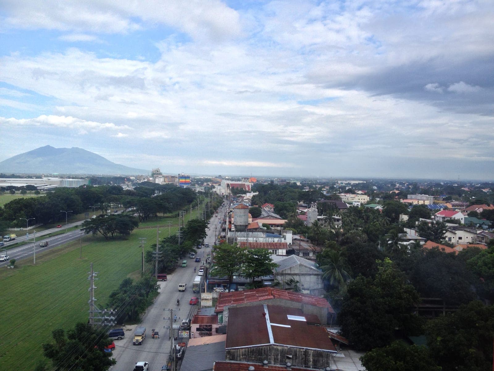 The Clark Freeport fence line from above, with Angeles City on one side and Mount Arayat on the horizon