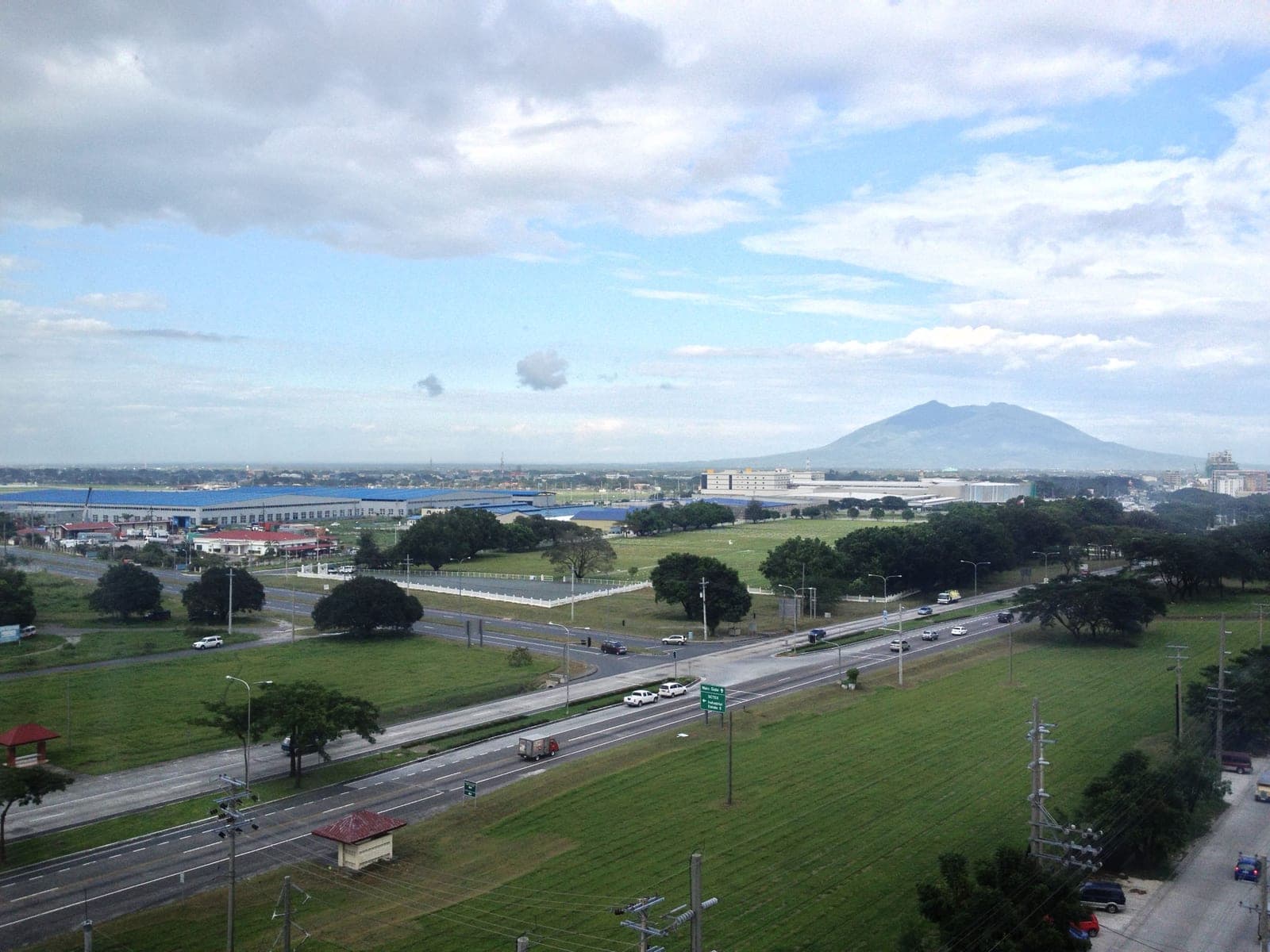 The main-gate highway and industrial estate inside Clark Freeport Zone, Mount Arayat in the distance