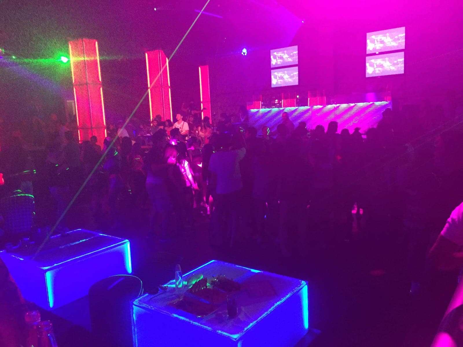 A live band on stage in an Angeles City nightclub, video screens and lasers over the crowd